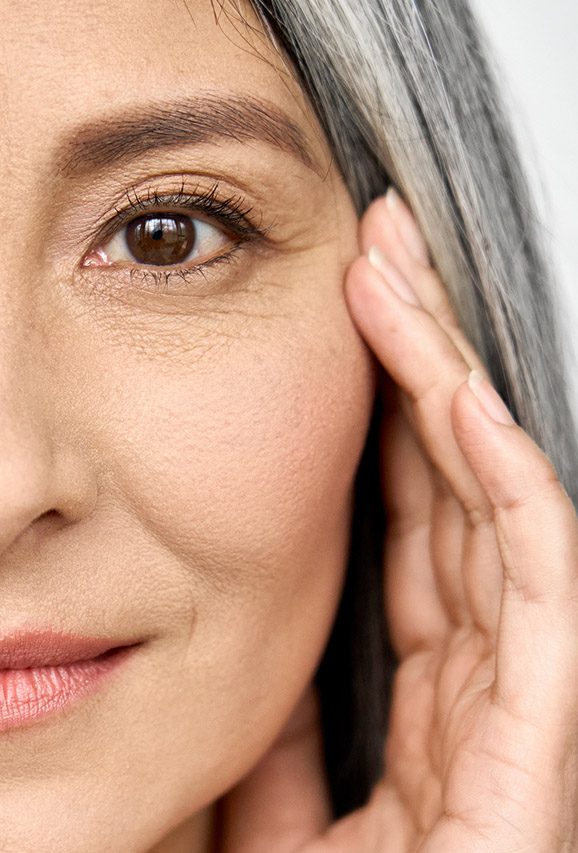 Photo of an older woman's face with fine lines and wrinkles