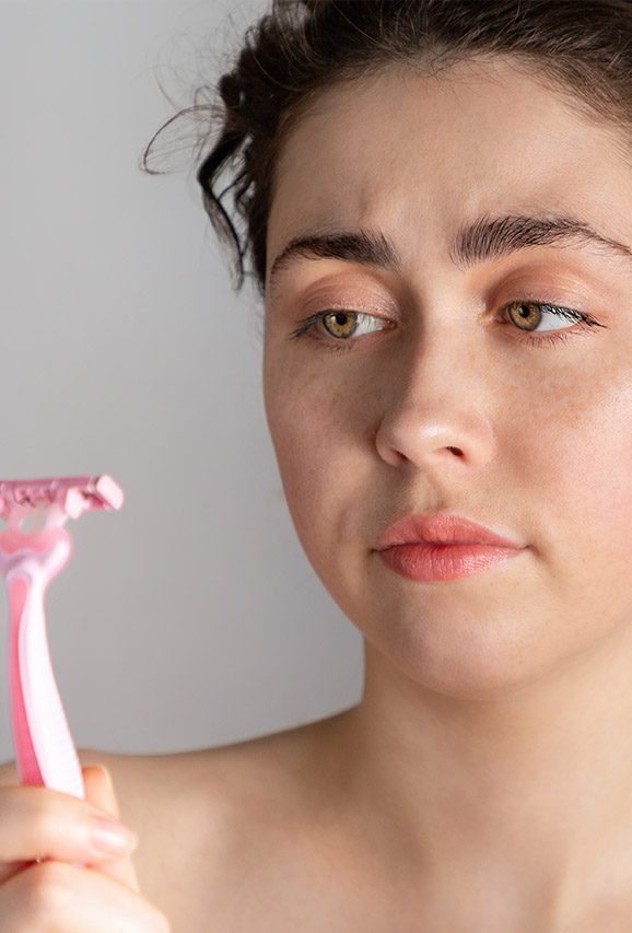 Photo of a woman staring her razor